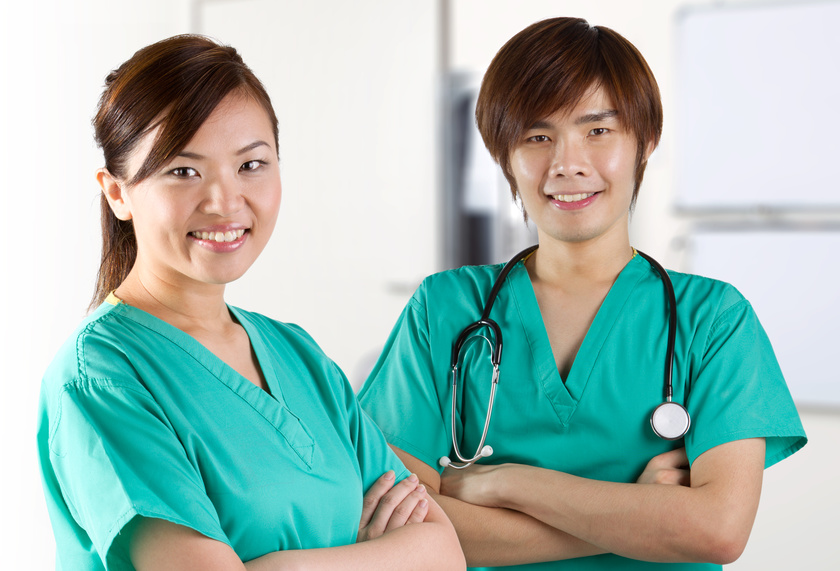 Two Asian doctors wearing green Scrubs